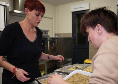 Résidente et monitrice préparent le réchauffage du repas.